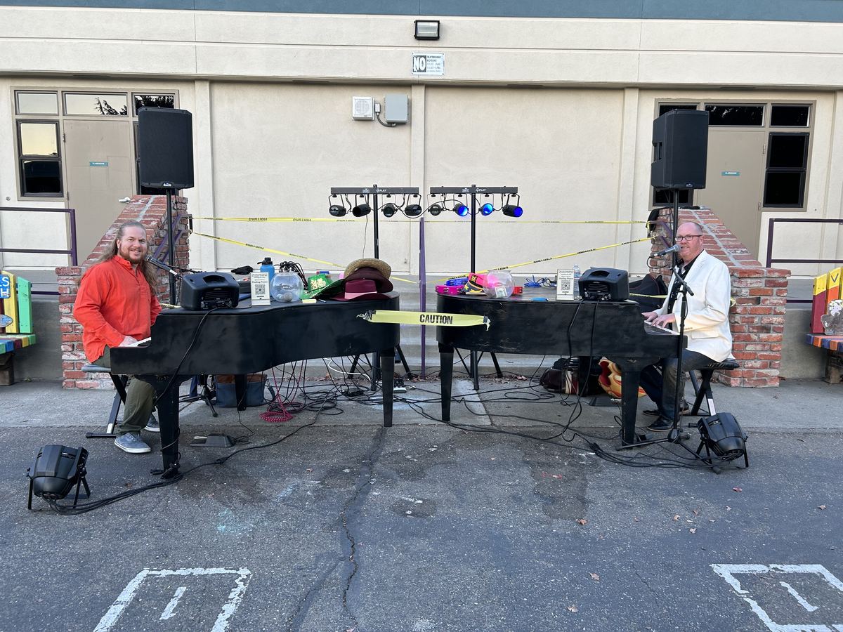 Two dueling piano shells with sound and lighting set up for an outdoor event